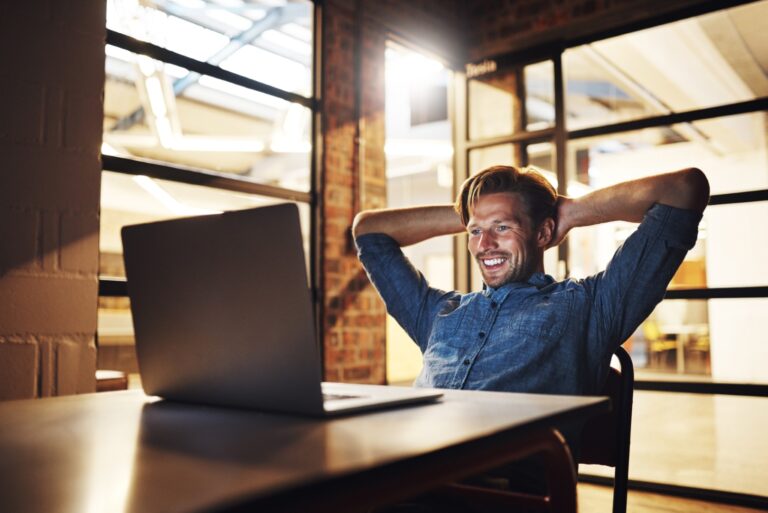 office man rest laptop night with smile email good news loan funding approval small business male person entrepreneur happy with reaching target task deadline Large